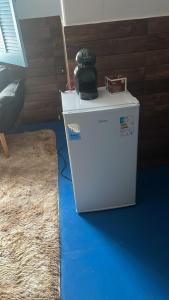 a white refrigerator with a camera on top of it at Cantinho da serra in Catas Altas