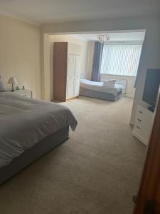 a bedroom with a bed and a television in it at Large 4 bedroom house in Heckington