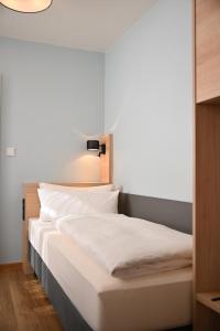 A bed or beds in a room at Hotel Mainblick Garni