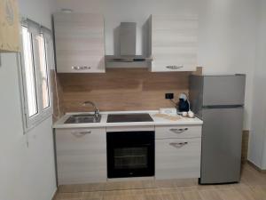 a kitchen with a sink and a refrigerator at Casa Vacanze ALeoFra in Taranto