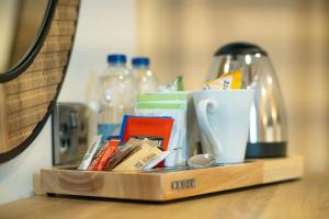 a wooden tray with cups and other items on a table at The Barmouth Bar & Grill in Barmouth
