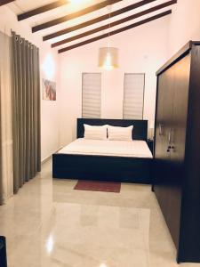 a bedroom with a bed in a room at Millennium Elite in Opata