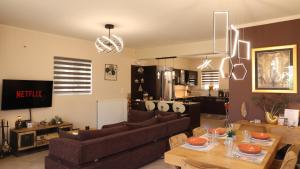 a living room with a couch and a table at villa strati in Nafplio