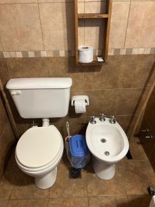 a bathroom with a toilet and a sink at Barranca Del Indio in Merlo