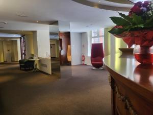 a lobby with a reception desk and a vase of flowers at Alli Due Buoi Rossi in Alessandria