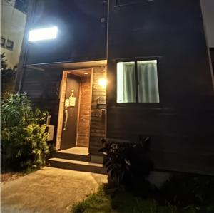 a front door of a house at night at Plage Yuigahama in Kamakura