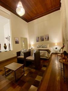 a living room with a bed and a couch at Casa Altos de Santa Teresa in Rio de Janeiro +77 photos