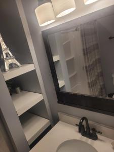a bathroom with a sink and a mirror and the eiffel tower at Green Meadow Cabin in Murfreesboro +18 photos
