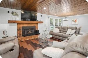 a living room with a couch and a fireplace at Green Meadow Cabin in Murfreesboro