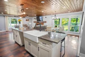a kitchen with a sink and a living room at Green Meadow Cabin in Murfreesboro