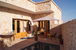 a house with a pool and a table and an umbrella at Villa Labri de la Plage 350 m from Beach & Center in Sidi Kaouki