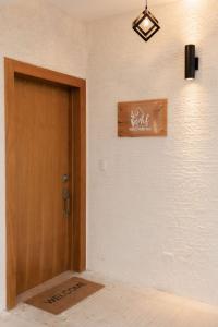 a room with a door and a sign on the wall at House of Flores Villa Bavaro in Punta Cana +29 photos