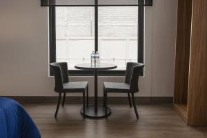 a dining room table and chairs in front of a window at Toronja C O V A D O N G A in Mexico City