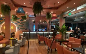 a restaurant with tables and chairs and a bar at Eleni Golden - Comfort Stay 2 in Loutra Oraias Elenis 