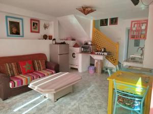 a living room with a couch and a table at Riad dar MUMTI in Saïdia
