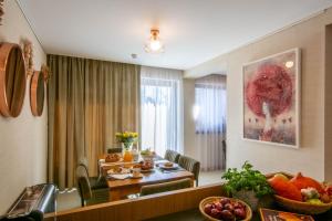 a living room with a table and a dining room at VILA DOMOVINA in Tatranská Lomnica