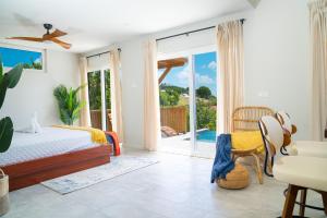 a bedroom with a bed and a sliding glass door at Coolidge Cottages in Osbourn