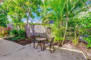 a table and chairs in front of a fence at Charming West Palm Beach Home in West Palm Beach