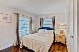 a bedroom with a bed and a window at Charming West Palm Beach Home in West Palm Beach