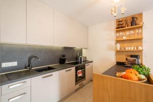 a kitchen with a sink and a counter with fruits and vegetables at VILA DOMOVINA in Tatranská Lomnica