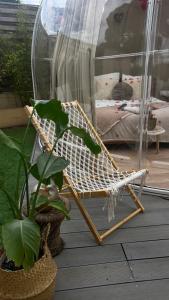 a hammock sitting on a porch next to a bedroom at Bulle insolite avec jacuzzi privé - Nature & romantisme a Fréjus in Fréjus +5 photos