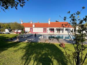 un grande edificio bianco con tetto rosso di MONTE DO CHAPARRO by Stay in Alentejo a Vila Nova de Milfontes