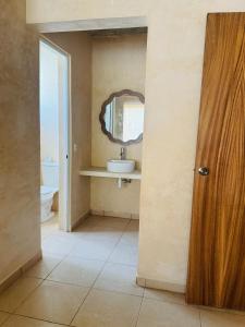 a bathroom with a sink and a mirror at Casa Tachu in Puerto Escondido +41 photos