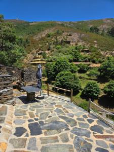 a stone walkway with a bench on top of a hill at Tojo Natur Piodão in Piódão +7 photos