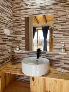 a bathroom with a white sink and a mirror at Gaucho Mendoza in Malargüe +8 photos
