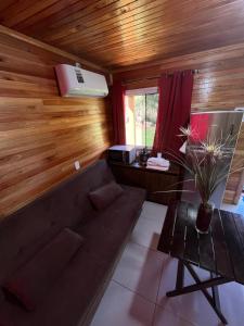 a living room with a couch and a table at Hotel, Pousada e camping Recanto Nativo Caibi in Palmitos