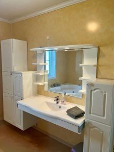 a bathroom with a sink and a mirror and a tub at Kronstad in Alta +9 photos