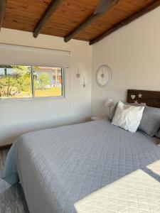 a bedroom with a bed and a clock on the wall at Aratiri Cabañas, Un Lugar En El Bosque.. in Colón +74 photos