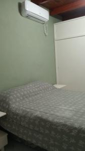 una camera da letto con un letto e una luce sul muro di Alojamiento Lindo Amanecer a Mercedes