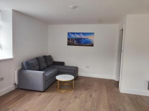 a living room with a couch and a table at Aran View Holiday Homes apartment in Doolin