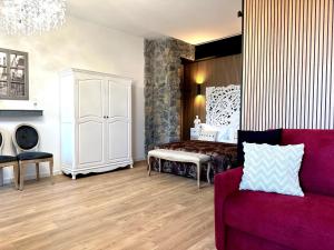 a living room with a bed and a couch at FORTUNA ORO Luxury Stay in Verona +92 photos