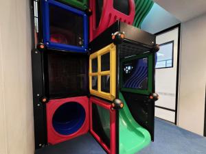 a childrens play room with a slide at Panania Hotel Sydney in Panania