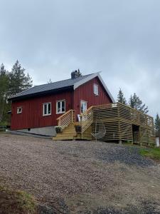 a red barn with wooden steps leading up to it at Drangedal Cabin House in Drangedal