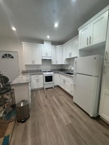 a kitchen with white cabinets and a white refrigerator at Stunning Guest House in West Hills California in Hughes-Canoga Park Heliport