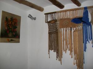 a bunch of beads hanging on a wall next to a painting at Luna11 in Alcañiz +45 photos