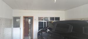 a black van parked in a room with a door at Casatelégrafo in Belém