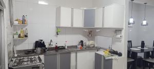a kitchen with white cabinets and a counter top at Casatelégrafo in Belém