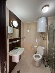 a bathroom with a toilet and a sink at Golden Sun in Pomorie +35 photos