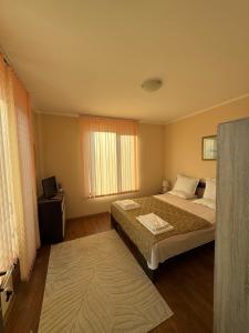 a hotel room with a bed and a window at Golden Sun in Pomorie