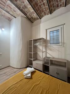 a room with a bed and a shelf and a window at La Reserve Albissola in Albissola Marina +9 photos