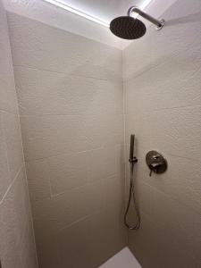 a bathroom with a shower with a shower head at La Reserve Albissola in Albissola Marina