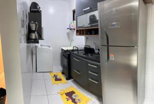 a kitchen with a stainless steel refrigerator at Apto 02 Quartos Mobiliado na Praia do Poço - CABEDELO in Cabedelo