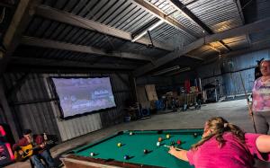 a group of people playing pool in a barn at Bells Marina & Fishing Resort - Santee Lake Marion by I95 - Family Adventure, Pets on Request! in Eutawville