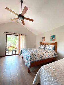 a bedroom with a bed and a ceiling fan at Villa Emilia - San Cristóbal, Dominican Republic in San Cristóbal
