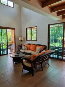a living room with a couch and a table at Villa Emilia - San Cristóbal, Dominican Republic in San Cristóbal