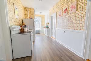 a kitchen with a white refrigerator and a wooden floor at 3BDR 2BA Downtown Salem with Parking in Salem +19 photos
